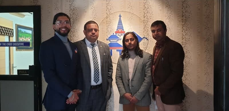 Samir with three others outside a chief executive's office