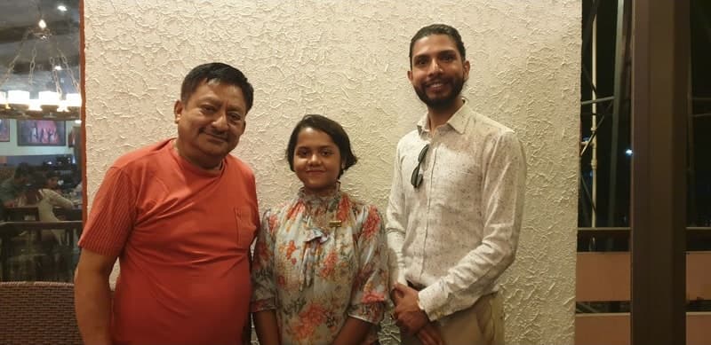 Samir with two guests at a restaurant